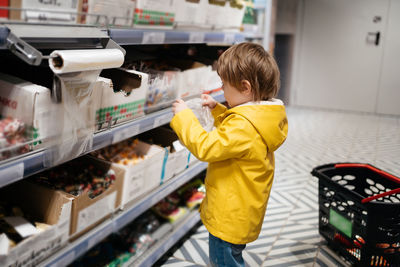 Side view of boy standing in factory