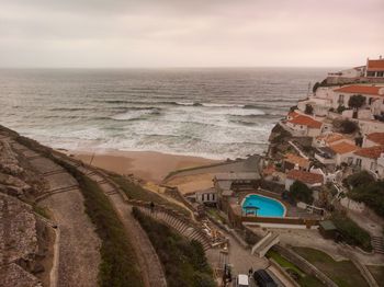 High angle view of sea and buildings against sky