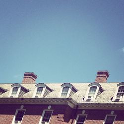 Low angle view of building against clear blue sky