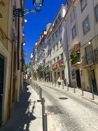 Street amidst buildings in city against sky