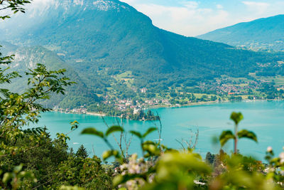 Scenic view of sea and mountains against sky