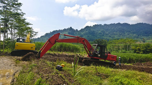 Panoramic view of machinery on field against sky