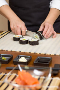 Midsection of man holding sushi