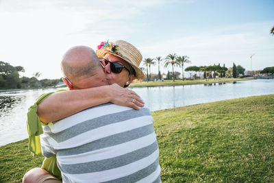 Rear view of couple kissing in water