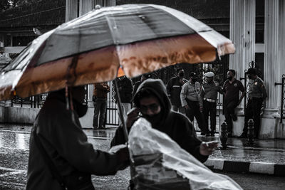 People holding camera in city