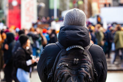 Rear view of people on street in city