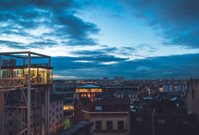 High angle view of illuminated buildings against sky at dusk