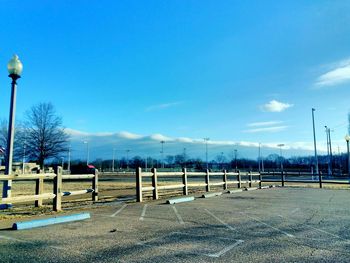Low angle view of soccer field against clear blue sky