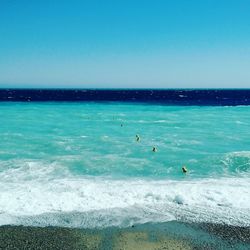 Scenic view of beach against blue sky