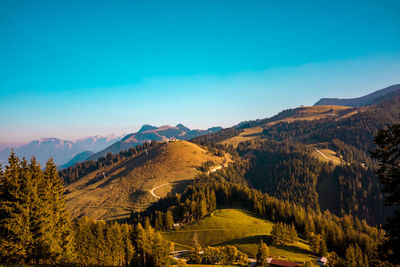 Scenic view of mountains against blue sky