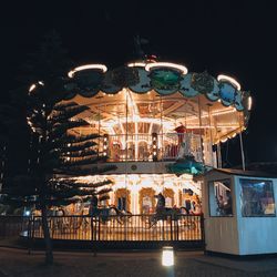 Illuminated amusement park ride at night