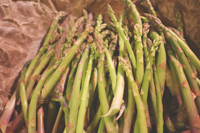 Close-up of asparaguses on paper