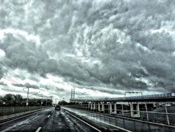 View of railroad tracks against cloudy sky