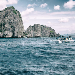 Rock formations in sea against sky