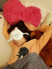 High angle view of woman sleeping on bed at home
