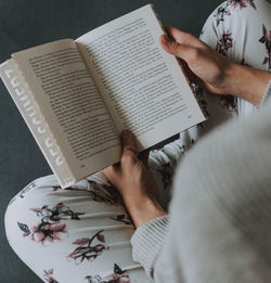 High angle view of woman reading book