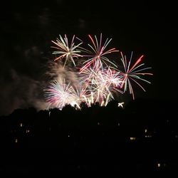 Low angle view of firework display at night