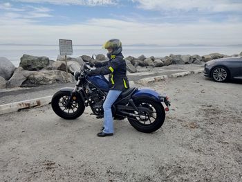 Man riding motor scooter on road