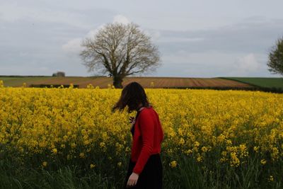 Rear view of woman standing on field