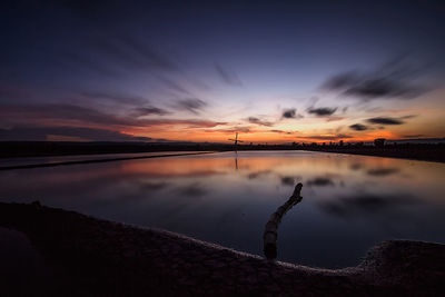 Scenic view of lake against sky during sunset