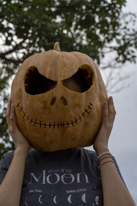 Cropped hand of woman with face paint