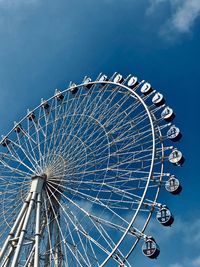 Low angle view of ferris wheel against sky