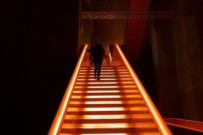 Rear view of person standing on staircase