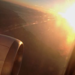 Cropped image of airplane flying over landscape