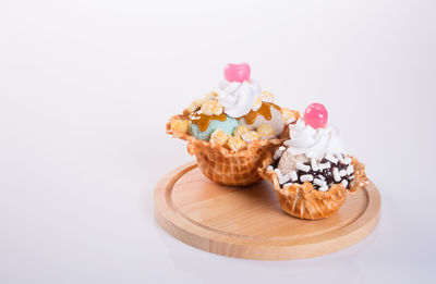 Close-up of cupcakes against white background