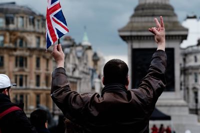 Rear view of a man holding british flag