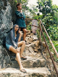 Full length of woman standing on tree trunk