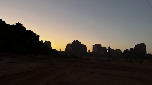 Scenic view of silhouette landscape against clear sky during sunset