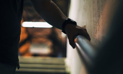 Close-up of hand holding railing