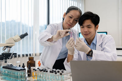 Portrait of female doctor examining patient in office