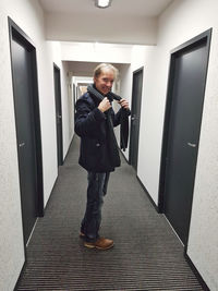 Full length of man standing in corridor