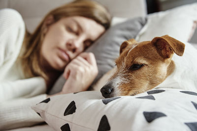 Woman sleep with dog on sofa