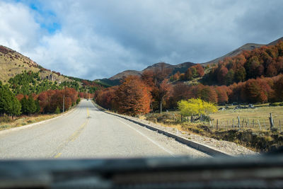 Road amidst mountains against sky