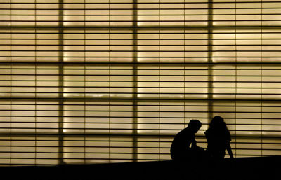 Silhouette couple on tiled floor