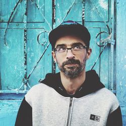 Portrait of man standing against wall