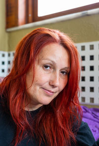 Close-up portrait of woman with redhead at home