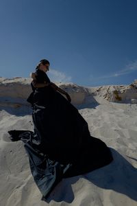 Rear view of man standing on snow covered mountain