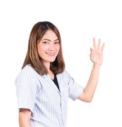 Portrait of a smiling young woman against white background