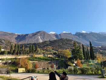 Scenic view of mountains against clear blue sky