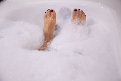 Low section of woman in bathtub