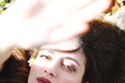 Close-up portrait of woman in sunlight