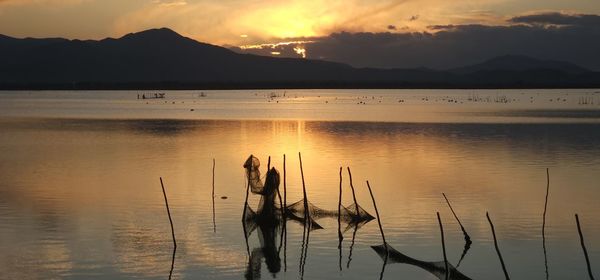 Scenic view of lake against sky during sunset