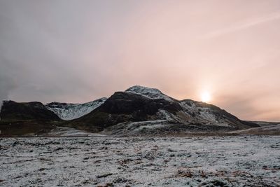 Scenic view of snowcapped mountains against sky during sunset