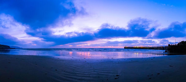 Panoramic view of beach against sky during sunset