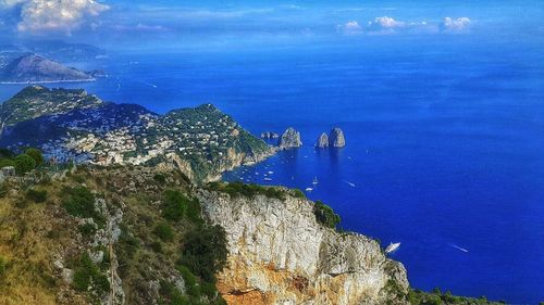 Panoramic view of sea and trees against blue sky