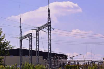 Low angle view of electricity pylon against sky